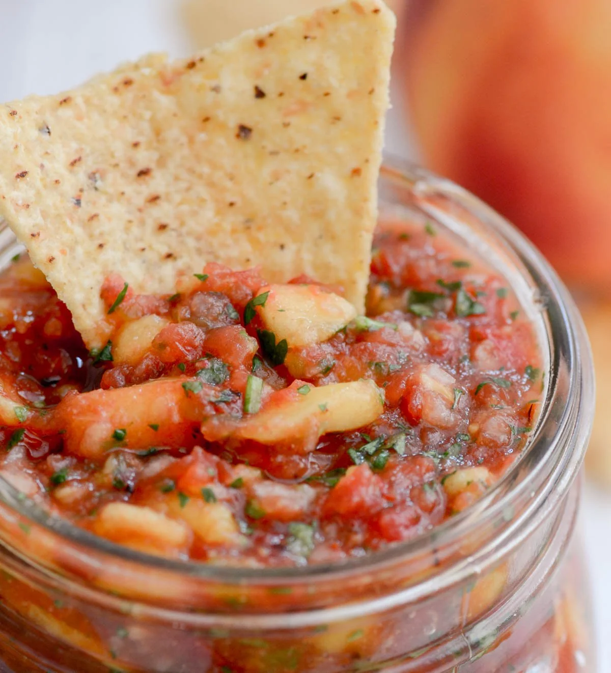 Bowl of easy homemade peach salsa with fresh ingredients.