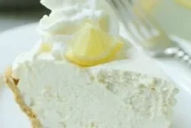Delicious Frozen Lemonade Pie garnished with lemon slices and whipped cream
