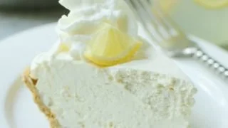 Delicious Frozen Lemonade Pie garnished with lemon slices and whipped cream