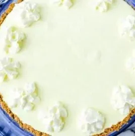 Delicious Frozen Lemonade Pie served with lemon slices and whipped cream