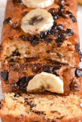 Delicious Greek Yogurt Banana Bread slice on a wooden table