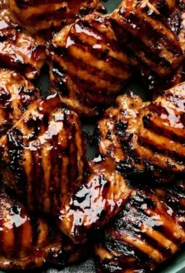 Delicious grilled teriyaki chicken with a shiny glaze on the grill