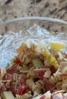 Colorful Grinder Pasta Salad with fresh vegetables and dressing