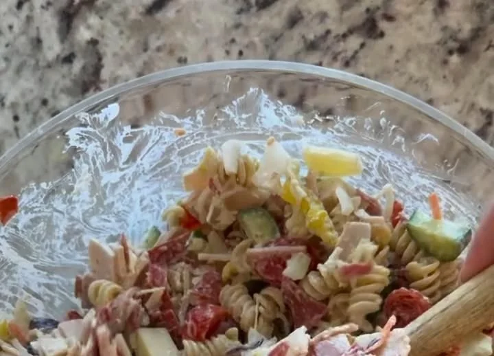 Colorful Grinder Pasta Salad with fresh vegetables and dressing