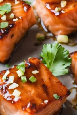 Delicious honey garlic salmon bites served on a plate with garnishes