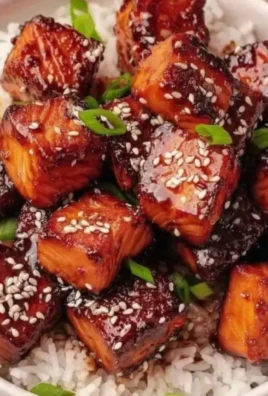 Honey Garlic Salmon Bites Bowl topped with fresh herbs and served in a bowl.