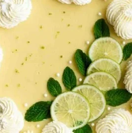 Delicious slice of Key Lime Pie with lime garnish on a white plate