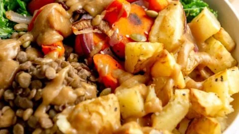 Colorful Lentil Nourish Bowl filled with fresh vegetables and herbs