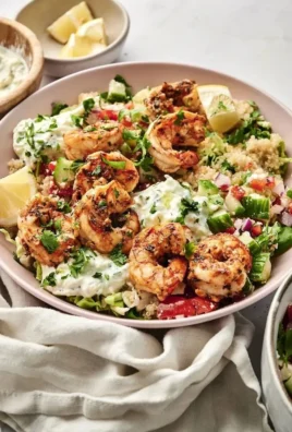 A vibrant Mediterranean shrimp bowl with fresh vegetables and flavorful spices