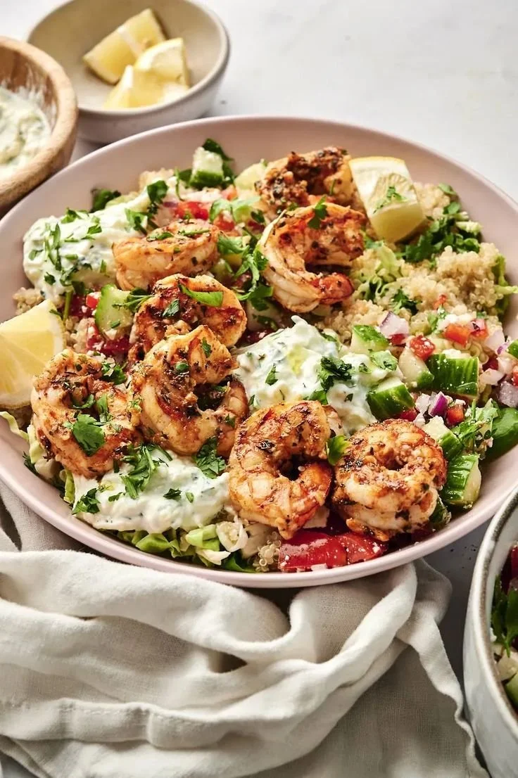 A vibrant Mediterranean shrimp bowl with fresh vegetables and flavorful spices