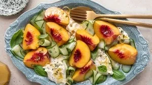 Fresh Peach Caprese Salad with Burrata cheese, basil, and vibrant colors.