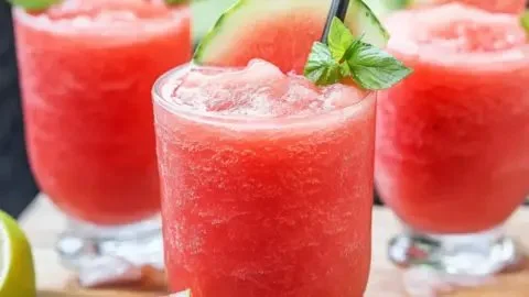 Refreshing watermelon slushie served in a glass with ice and mint leaves
