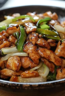 Delicious stir-fried teriyaki chicken served with vegetables and rice.