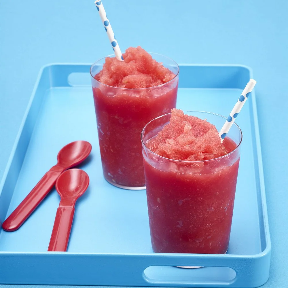 Refreshing watermelon slushy in a glass with ice and a slice of watermelon