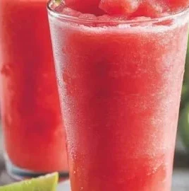 A vibrant watermelon strawberry slush served in a glass with mint garnish