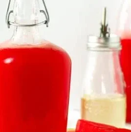 Bottle of homemade watermelon syrup for refreshing beverages and desserts
