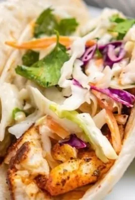 Crispy Air Fryer fish tacos served on a plate with fresh toppings