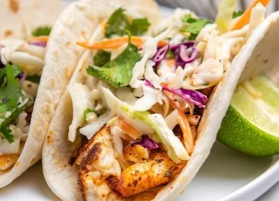 Crispy Air Fryer fish tacos served on a plate with fresh toppings