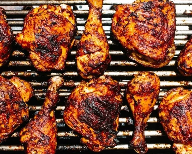 Grilled BBQ chicken served with vibrant sides for a perfect summer meal.