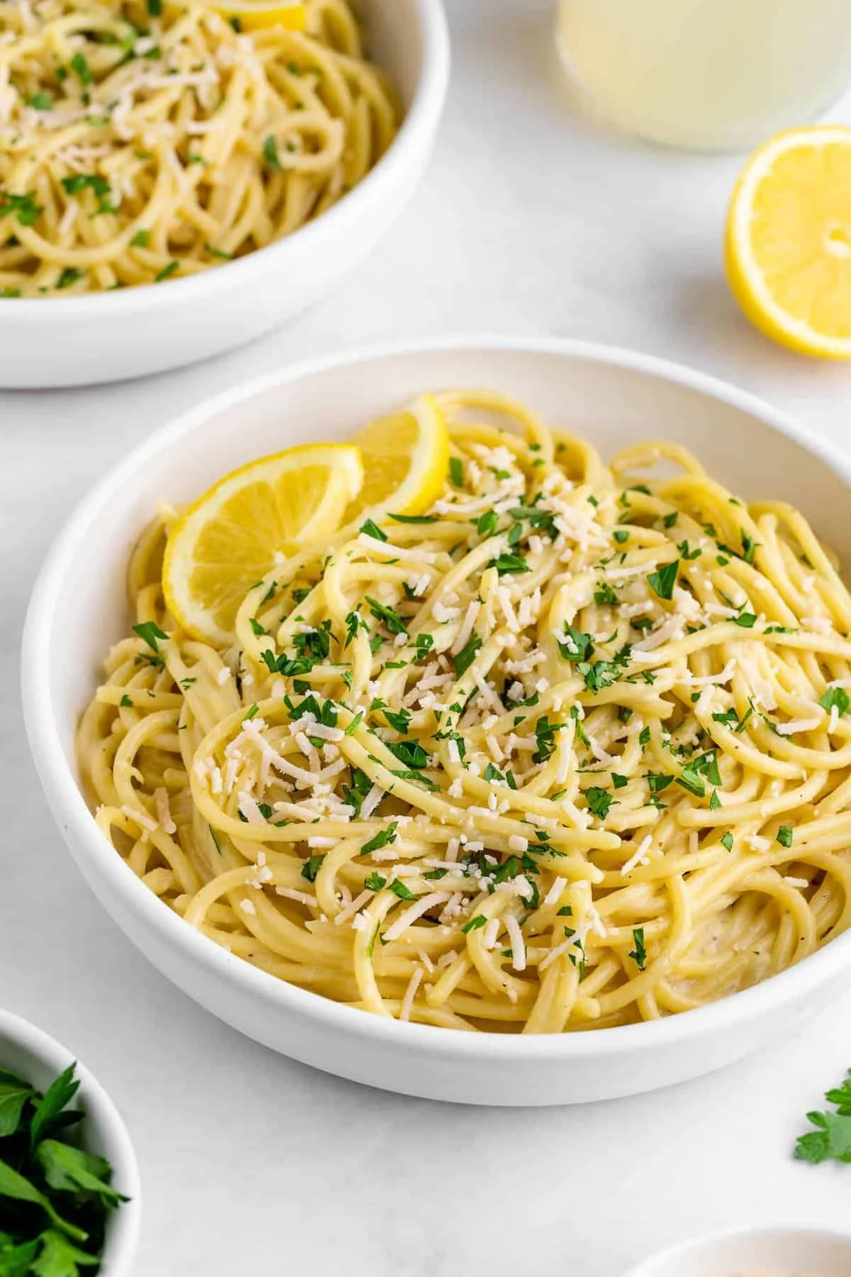 Creamy vegan lemon pasta garnished with fresh herbs and lemon zest