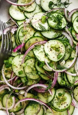 Fresh Cucumber Salad with herbs and dressing in a bowl