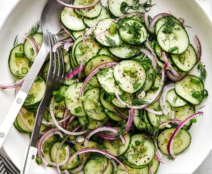 Fresh Cucumber Salad with herbs and dressing in a bowl