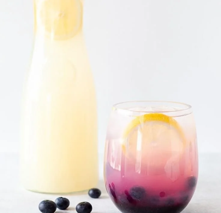 Glass of refreshing easy blueberry lemonade with fresh blueberries and lemon slices