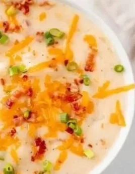 Bowl of creamy Easy Crock Pot Potato Soup garnished with chives.