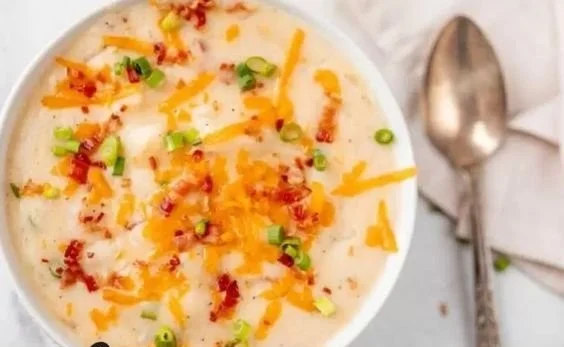 Bowl of creamy Easy Crock Pot Potato Soup garnished with chives.