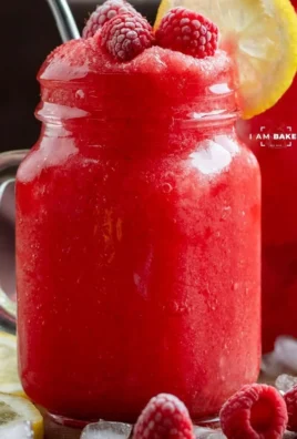 Refreshing frozen raspberry lemonade served in a glass with ice