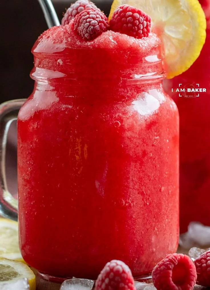 Refreshing frozen raspberry lemonade served in a glass with ice