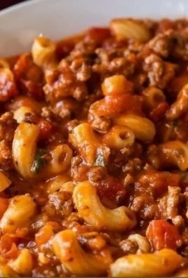 Plate of delicious ground beef goulash with pasta and vegetables