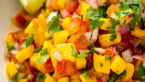 Fresh Mango Salsa Fresca served in a bowl with chips and garnishes