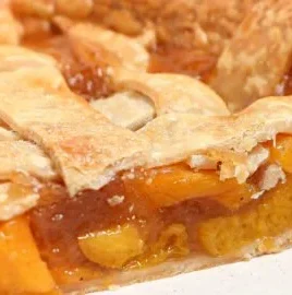 Homemade Peach Pie with a golden flaky crust and juicy peach filling.