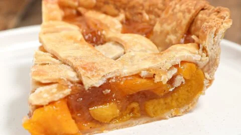 Homemade Peach Pie with a golden flaky crust and juicy peach filling.
