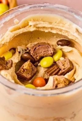 Peanut butter cup protein ice cream served in a bowl with chocolate drizzle