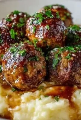 Delicious Salisbury Steak Meatballs with garlic herb mashed potatoes on a plate