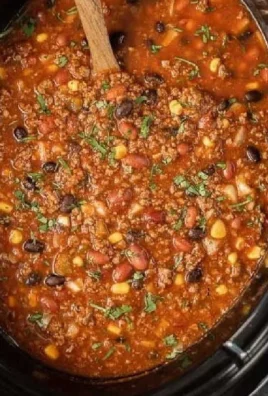 Bowl of slow cooker taco chili with toppings, showcasing a hearty meal.