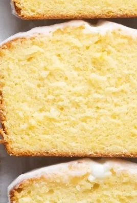 Starbucks copycat lemon loaf with a slice showcasing its moist texture and lemon glaze.