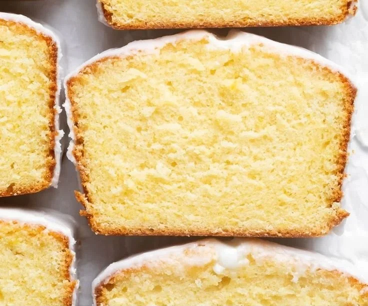 Starbucks copycat lemon loaf with a slice showcasing its moist texture and lemon glaze.