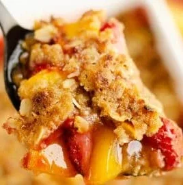 Delicious strawberry peach crisp dessert with a golden topping