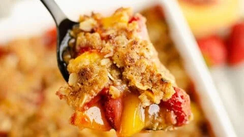 Delicious strawberry peach crisp dessert with a golden topping