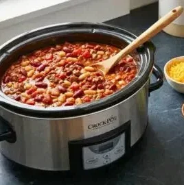 Delicious bowl of the best ever crockpot chili topped with cheese and herbs
