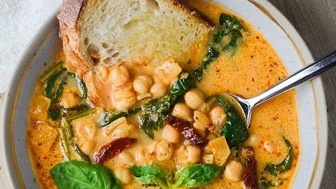 Bowl of Tuscan Garbanzo Bean Soup with fresh herbs and vegetables